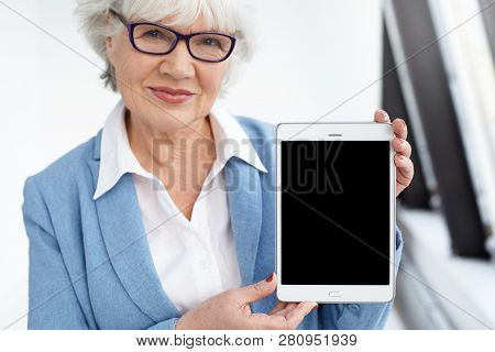 Modern Technology, Aging And Online Communication Concept. Attractive Happy Mature Sixty Year Old Bu