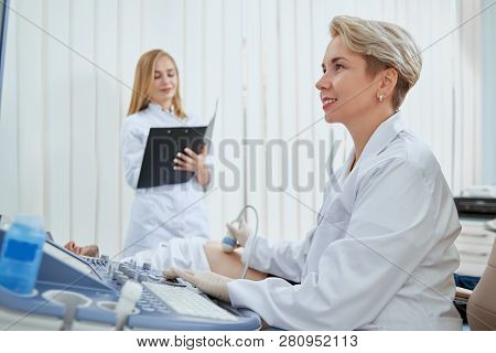 Side View Of Women In Doctors Office Working With Sick Patients. Exellent Spesialist Providing Medic