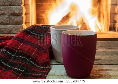 Mugs Of Hot Tea, Wol Scarf Near Cozy Fireplace, In Country House, Winter Vacation.