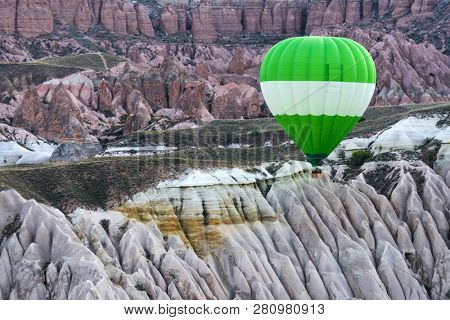 Green ballon in the sunrise mountains. Cappadocia, Turkey. Landscape photography