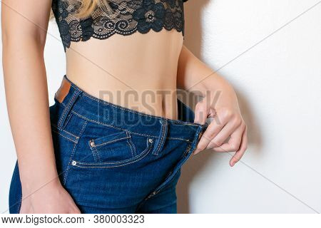 Young Woman In Jeans Too Big Size Because Of Losing Weight. Weight Control, Weight Loss, Slim Body, 