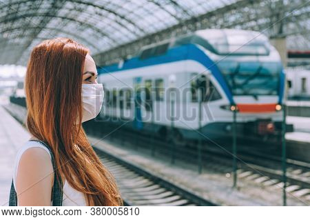 Girl In A Medical Mask, At The Railway Station.