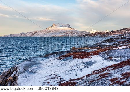 Frozen Tundra Landscape With Cold Greenlandic Sea And Snow Sermitsiaq Mountain In The Background, Ne