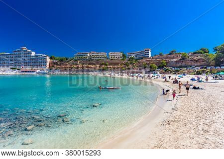 PORT ADRIANO, MALLORCA, SPAIN - 23 July 2020 - Tourists enjoying summer day on the popular city beach.