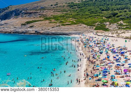 CALA MESQUIDA, MALLORCA, SPAIN - 19 July 2020: People enjoying beautiful sandy beach of on Mallorca, Mediterranean Sea, Balearic islands, Spain.