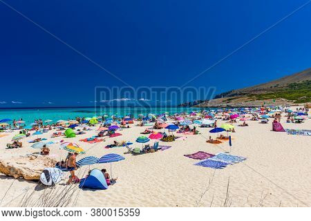 CALA MESQUIDA, MALLORCA, SPAIN - 19 July 2020: People enjoying beautiful sandy beach of on Mallorca, Mediterranean Sea, Balearic islands, Spain.