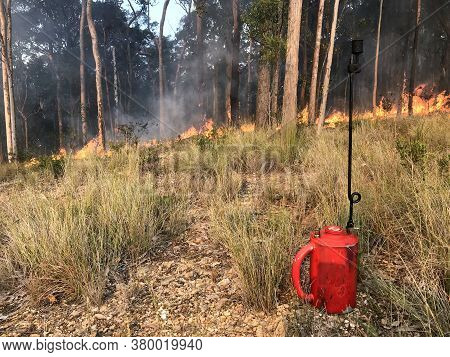 Drip Torch With Fire In The Background