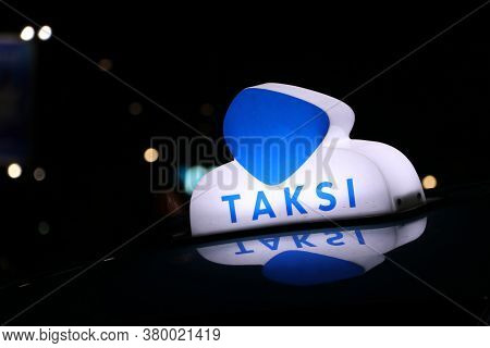 Taxi Light Sign Or Cab Sign In Blue And White Color On The Car Roof At The Street In The Dark Night,
