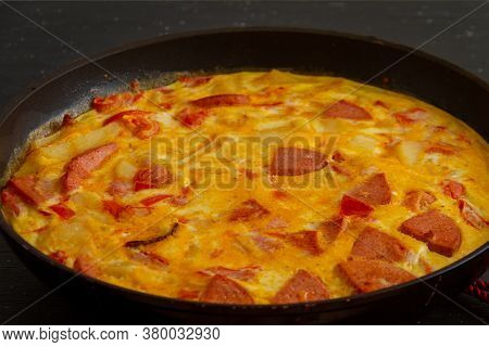 Fritata. Rustic Omelet With Potatoes, Tomatoes, Cheese And Sausage In A Pan.