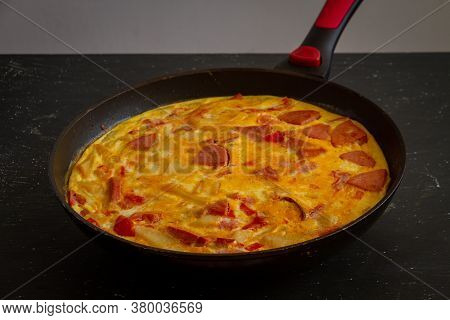Fritata. Rustic Omelet With Potatoes, Tomatoes, Cheese And Sausage In A Pan.