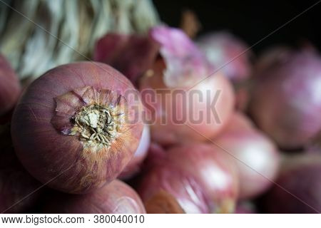 Bunch Of Onions On Wooden Tablel With Copy Space, Shadow Concept