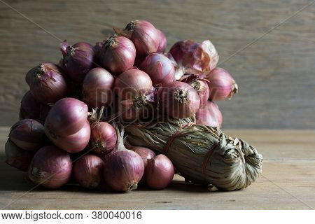 Bunch Of Onions On Wooden Tablel With Copy Space, Shadow Concept