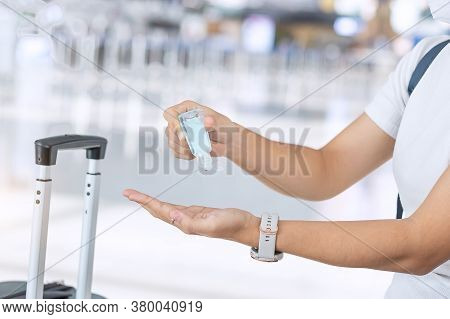 Woman Clean Hand By Alcohol Gel Sanitizer After Holding Handle Luggage Bag In Airport, Protection Co