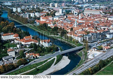 Aerial View To The City Celje In Slovenia. Red Roofs, River And The Bridge. Outdoor Travel Backgroun