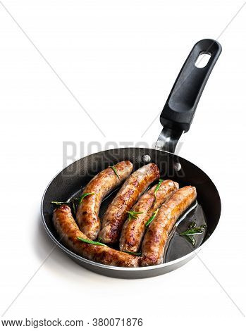 Delicious  Pork Chipolatas Sausages In A Frying Pan Isolated On White