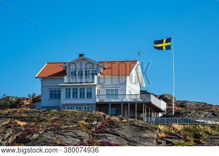 Building And Flag On The Island Dyroen In Sweden.