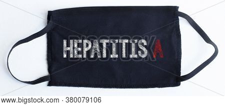Black Disposable Protective Mask With Hepatits A Text On Black Background.