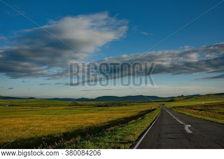 Russia. Republic Of Khakasia. Endless Steppes Among Picturesque Hilly Mountains Near The Village Of 