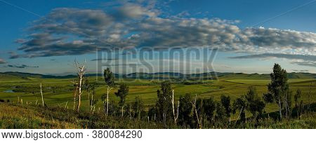 Russia. Republic Of Khakasia. Endless Steppes Among Picturesque Hilly Mountains Near The Village Of 