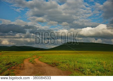 Russia. Republic Of Khakasia. Endless Steppes Among Picturesque Hilly Mountains Near The Village Of 