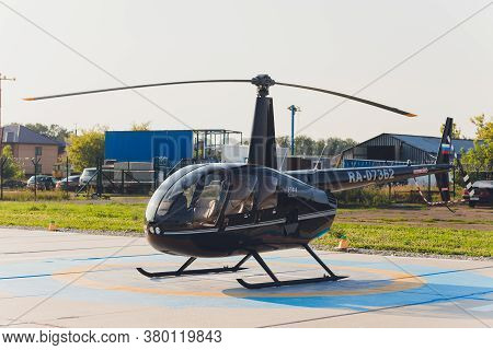 Ufa, Russia, 3 June, 2020: Small Helicopter Parked At The Helipad. Luxury Lifestyle Robinson R44.