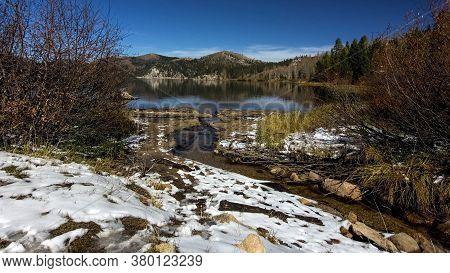 Overview Of Marlette Lake In The Fall, Highlighting Yellow Vegetation And A Thin Layer Of Snow On Th