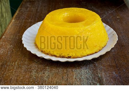 Closeup On Quindim, A Tasty Yellow Brazilian Dessert Made With Condensed Milk And Eggs On Grunge Woo