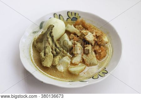 Lontong Sayur Or Ketupat, Indonesian Cuisine. Compressed Rice Cake Or Lontong With Vegetables Cooked