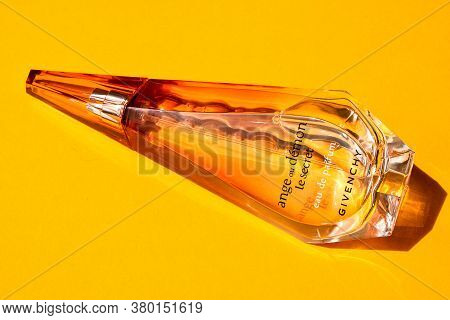Zhytomyr, Ukraine - June 2, 2020. A Clear Orange Glass Spray Bottle Of Givenchy Ange Ou Demon Le Sec