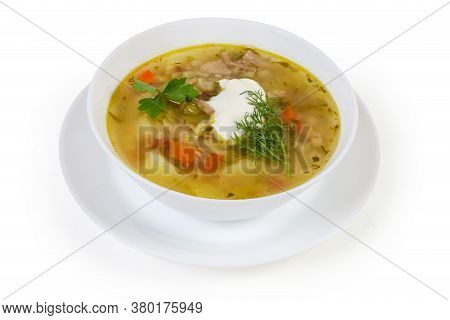 Serving Of Rassolnik - Meat Soup With Pearl Barley And Pickled Cucumbers Seasoned With Sour Cream On