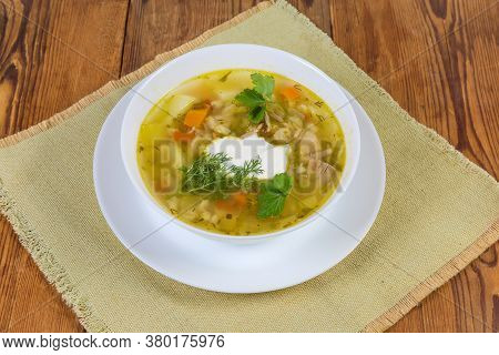 Serving Of Rassolnik - Meat Soup With Pearl Barley And Pickled Cucumbers Seasoned With Sour Cream, S