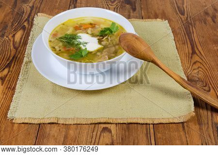 Portion Of Rassolnik - Meat Soup With Pearl Barley And Pickled Cucumbers Seasoned With Sour Cream, W