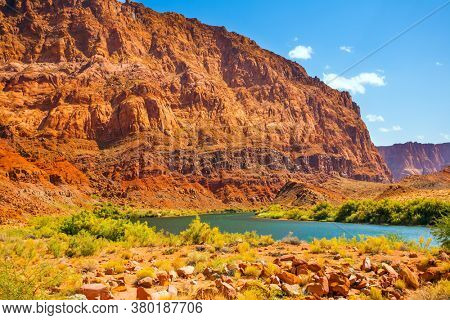 USA. Historic boat crossing Lee's Ferry. Amazing wildlife. Steep river banks of red sandstone. Smooth turn of the magnificent Colorado River. The concept of active, extreme and photo tourism