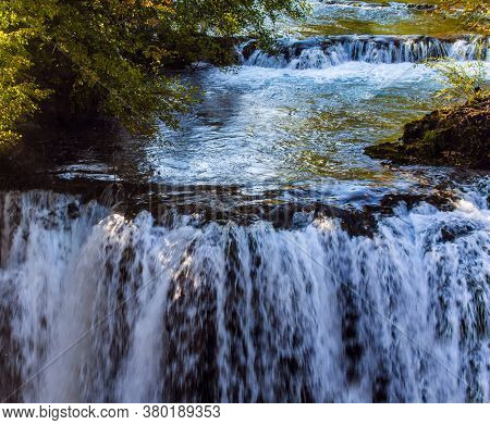 Trip to Croatia. The smal town of Slunj. Magnificent cascade of waterfalls on the Korana River. The forest surround the river. The concept of ecological, active and photo tourism