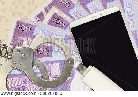 100 Philippine Piso Bills And Smartphone With Police Handcuffs. Concept Of Hackers Phishing Attacks,