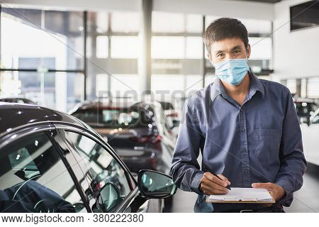 Asian Saleman Wear Surgical Mask Working In Inspector Checking Writing On Clipboard In Garage Of Dea