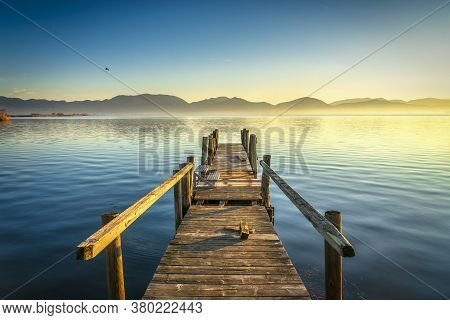 Wooden Pier Or Jetty And Lake At Sunrise. Torre Del Lago Puccini, Versilia, Massaciuccoli Lake, Tusc