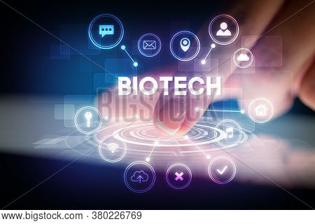Finger touching tablet with web technology icons and BIOTECH inscription, web technology concept