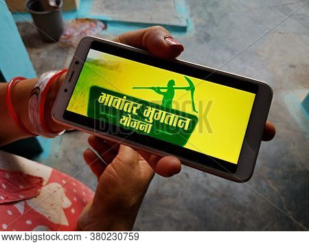 District Katni, India - May 23, 2020: Woman Holding Smart Phone With Displayed Bhavantar Bhugtan Yoj