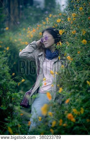 Portrait Woman In Yellow Flower Blooming Field