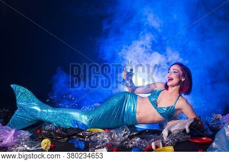 Ocean Plastic Pollution Concept. Mermaid Lives To Polluted Habitat.