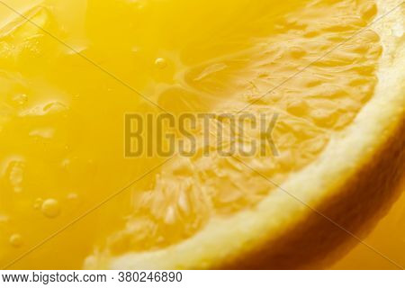 Top View Macro Detail Of Slice Of Orange Floating In Crushed Ice Of Orange Margarita Cocktail With T