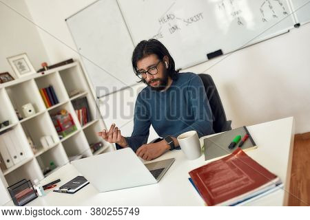Learn To Code. Young Focused Bearded Male Teacher Teaching Computer Science Online. Looking At Webca