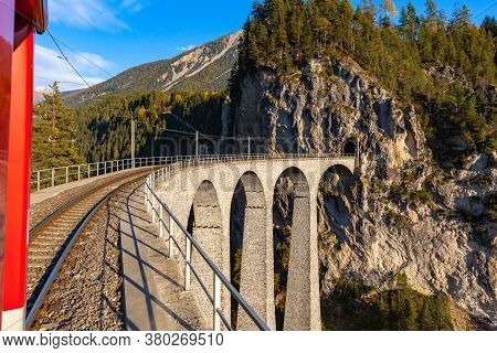 Travel With The Red Rhaetian Railway Sightseeing Train Bernina Express Running Over Landwasser Viadu