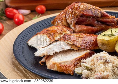 Roasted Turkey Served On A Plate With Farofa, Crumbs And Boiled Potatoes. Thanksgiving Day And Chris