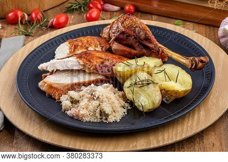 Roasted Turkey Served On A Plate With Farofa, Crumbs And Boiled Potatoes. Thanksgiving Day And Chris