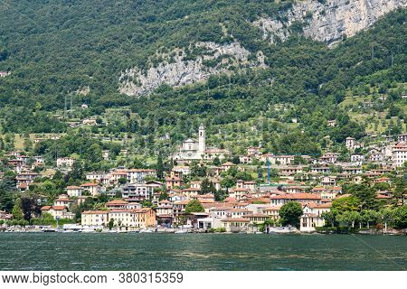 Waterfront of Mezzegra Municipality on Lake Como. Lombardy. Italy. Panorama with Mountains and Forest.