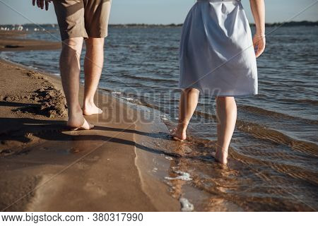 Couple In Love On The Beach.young Man And Woman Walking On Seashore And Laughing.