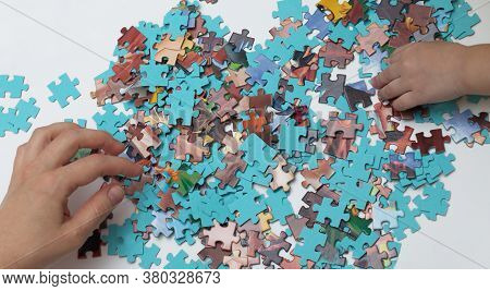 We Collect A Puzzle With The Child. Have Fun With Your Baby. Relaxtion Strategy. Family Teamwork. Co