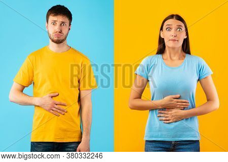 Young Female And Male Touching Stomaches, Feeling Satiety After Eating Hearty Meal, Biting Lips, Hav